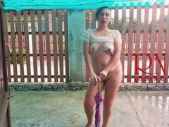 Sultry MILF gets drenched in the rain, showing off wet panties!