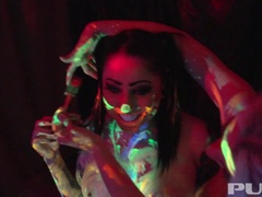 Black-light babes Nadia and Ophelia suck off a colorful cock