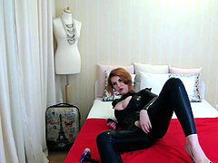 ginger-haired Camgirl in spandex Catsuit plays with faux-cock