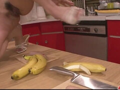 Watch this sexy redhead play with a hard banana in the kitchen & get pounded hard!