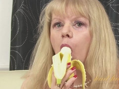 Amanda sucks a banana in stockings and masturbates.