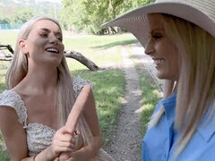 Candee Licious and Emily Belle licking in the woods