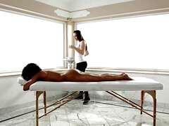 Black woman is getting a massage as foreplay for fingering