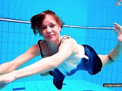 Teen girl Avenna is swimming in the pool